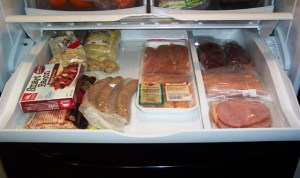 fridge-inside2 The Meaty Deli Drawer: fake bacon, real bacon, bratwurst, chicken tenders, sirloin steaks, hot dogs, ham, and some other stuff I don't remember putting in there. I think there may be some gingerroot in the back.